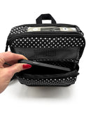 Polka dot portable oxygen concentrator carry bag with mesh pocket and woman placing phone inside